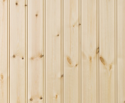 Ljus träpanel med pärlspontmönster och synliga kvistar.