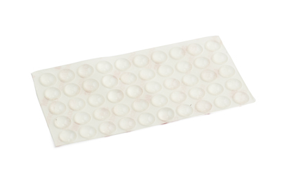 Transparenta runda självhäftande dämpare på en rektangulär plastfilm.